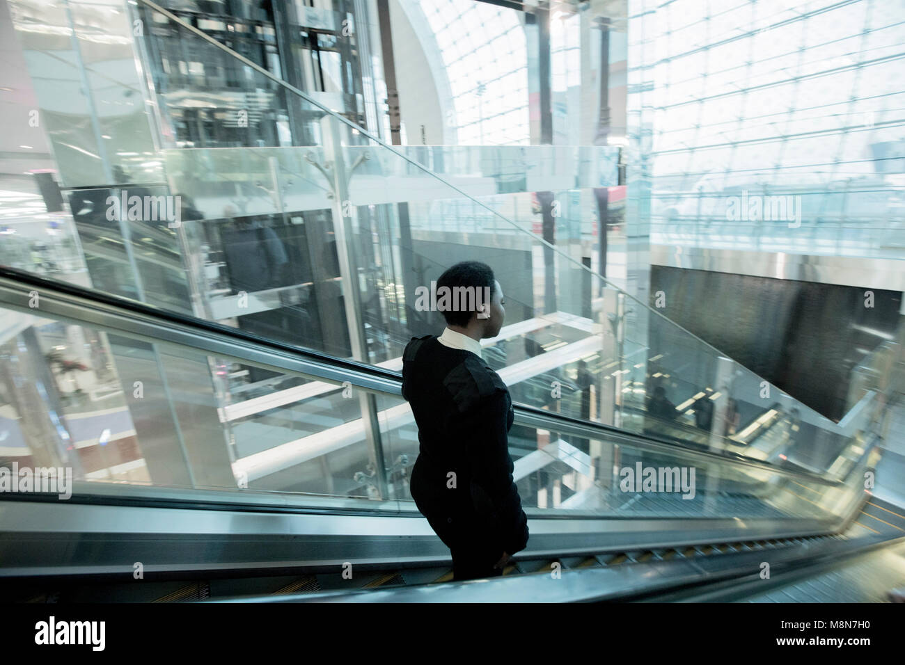 Airport staff, escalator, Dubai International Airport Stock Photo