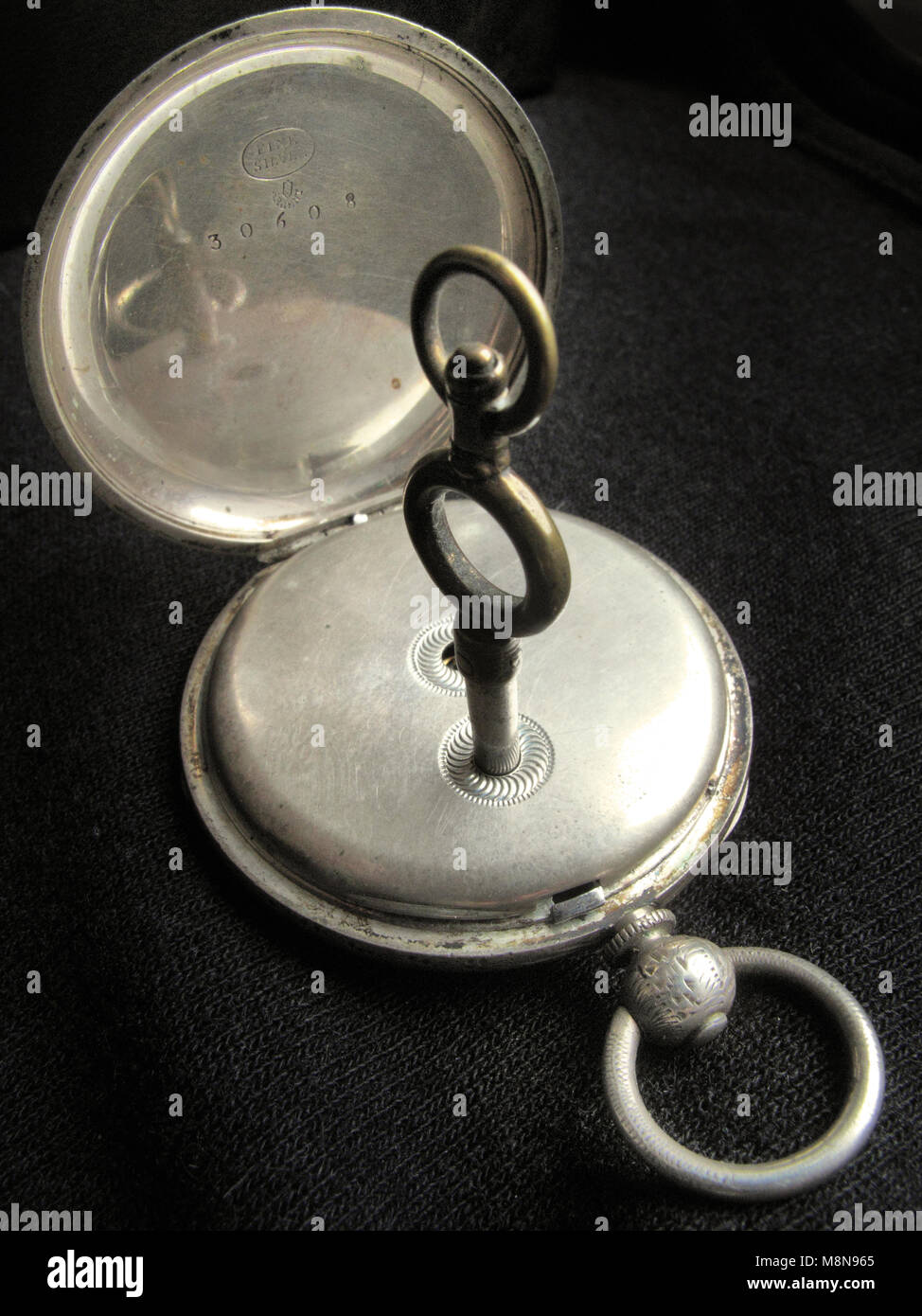 antique pocket watch with winding key Stock Photo