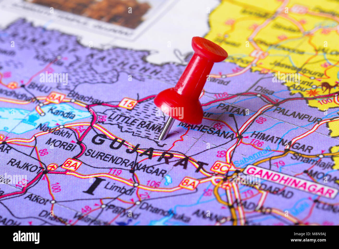Close view of Pushpin pointing to Gujarat on a map of India Stock Photo
