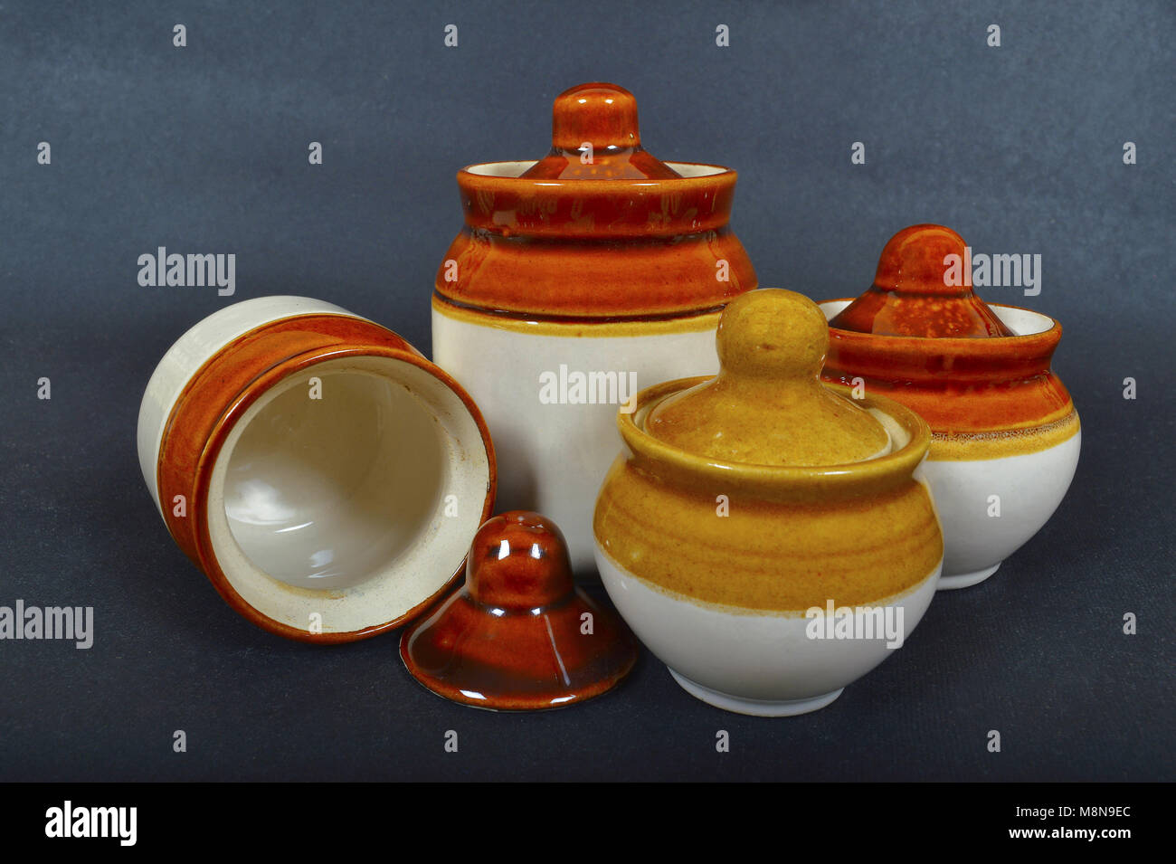 Close view of traditional pickle Jars of ceramic on black background Stock Photo