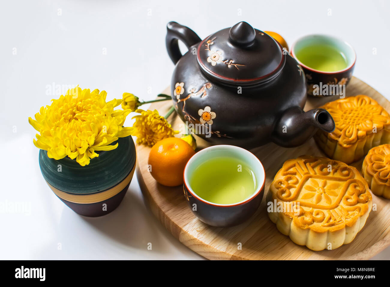 Moon cake and tea for Chinese mid autumn festival. Isolated on white. Copy space Stock Photo