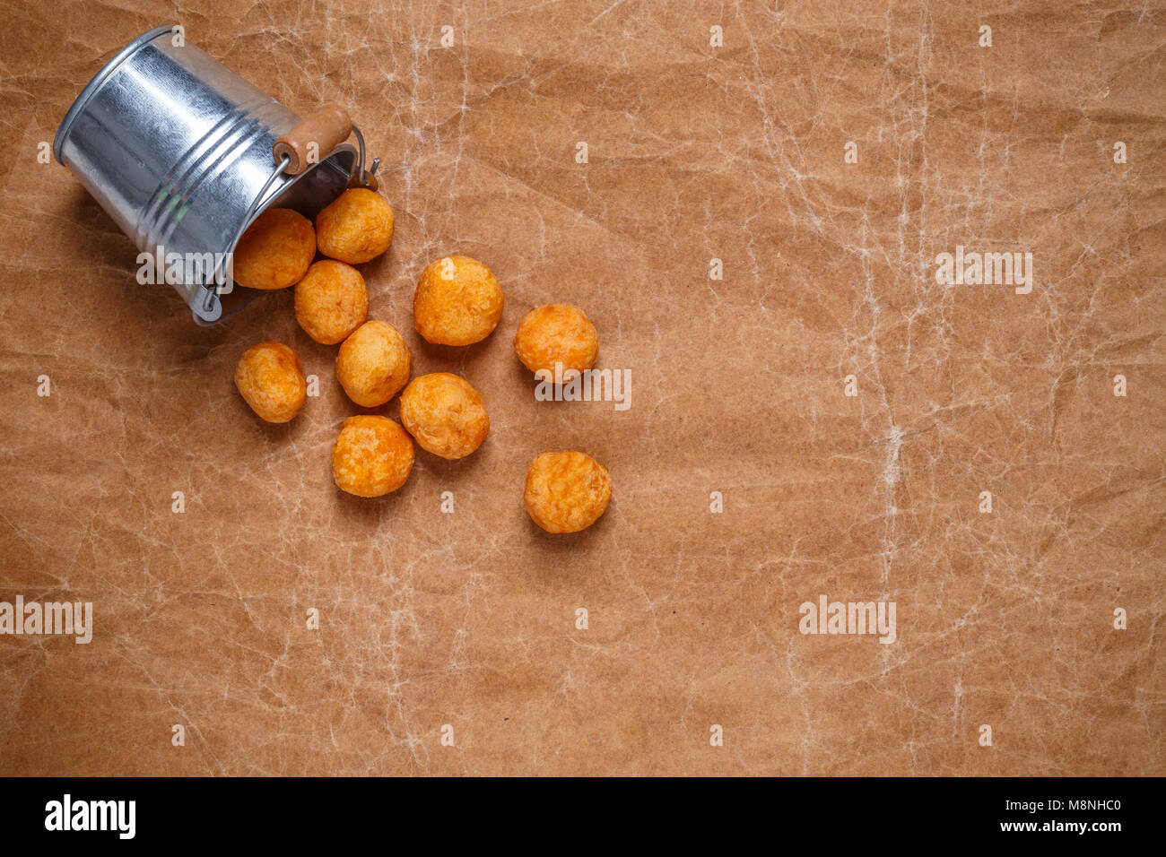 Top view deep fried sweet potato balls on crumpled brown paper background Stock Photo