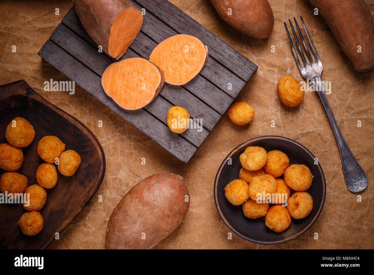Thai fried sweet potato balls on brown background Stock Photo