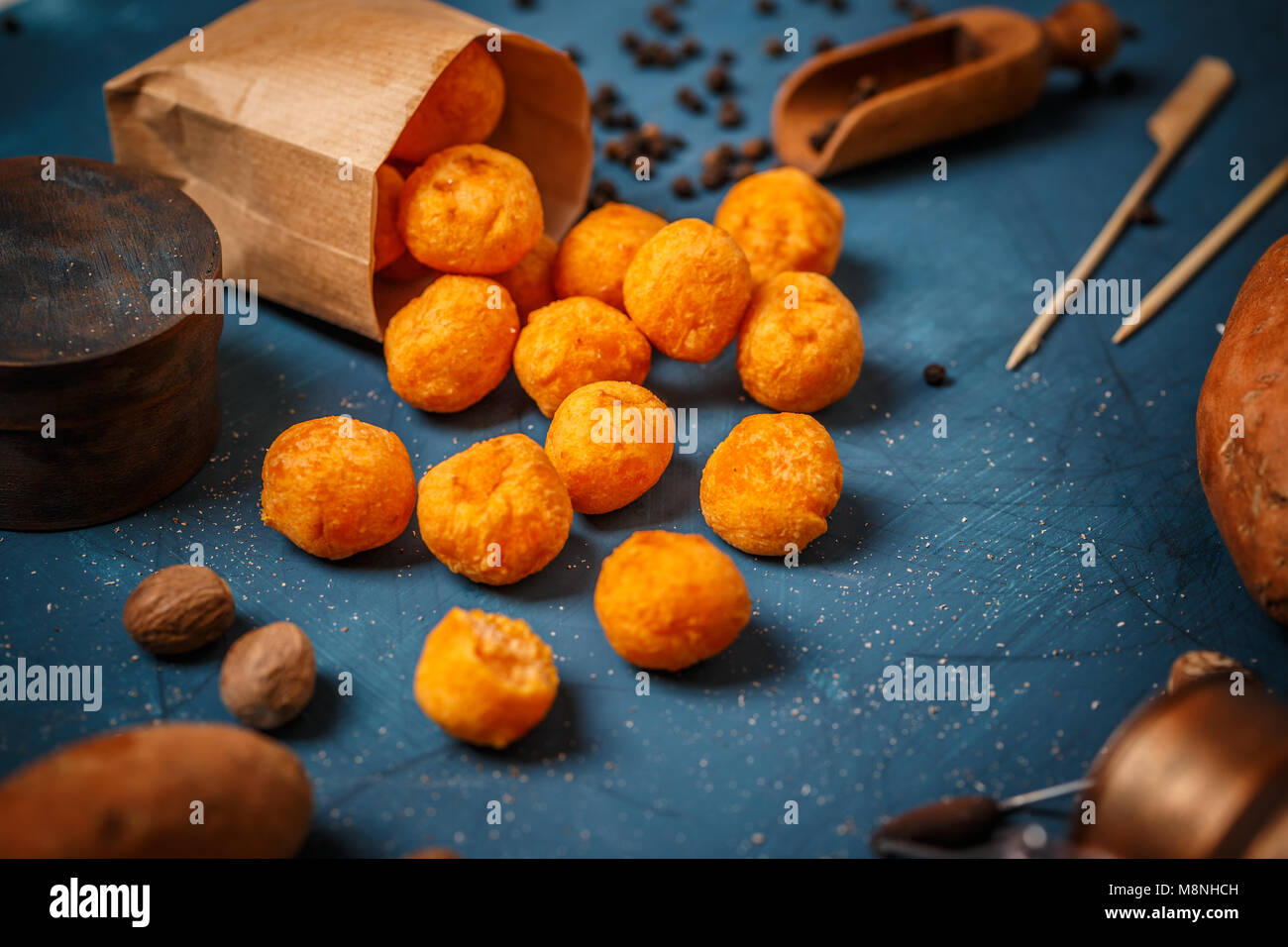 Sweet potato croquettes in a paper bag on blue background Stock Photo