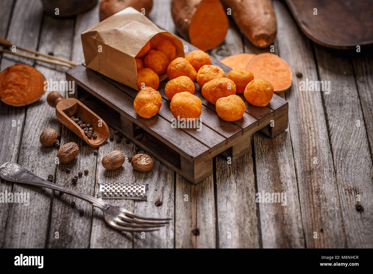 Fried sweet potato balls on wooden background Stock Photo
