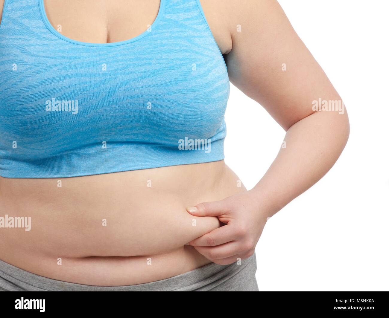 Overweight woman holding the fat around her waist. Stock Photo