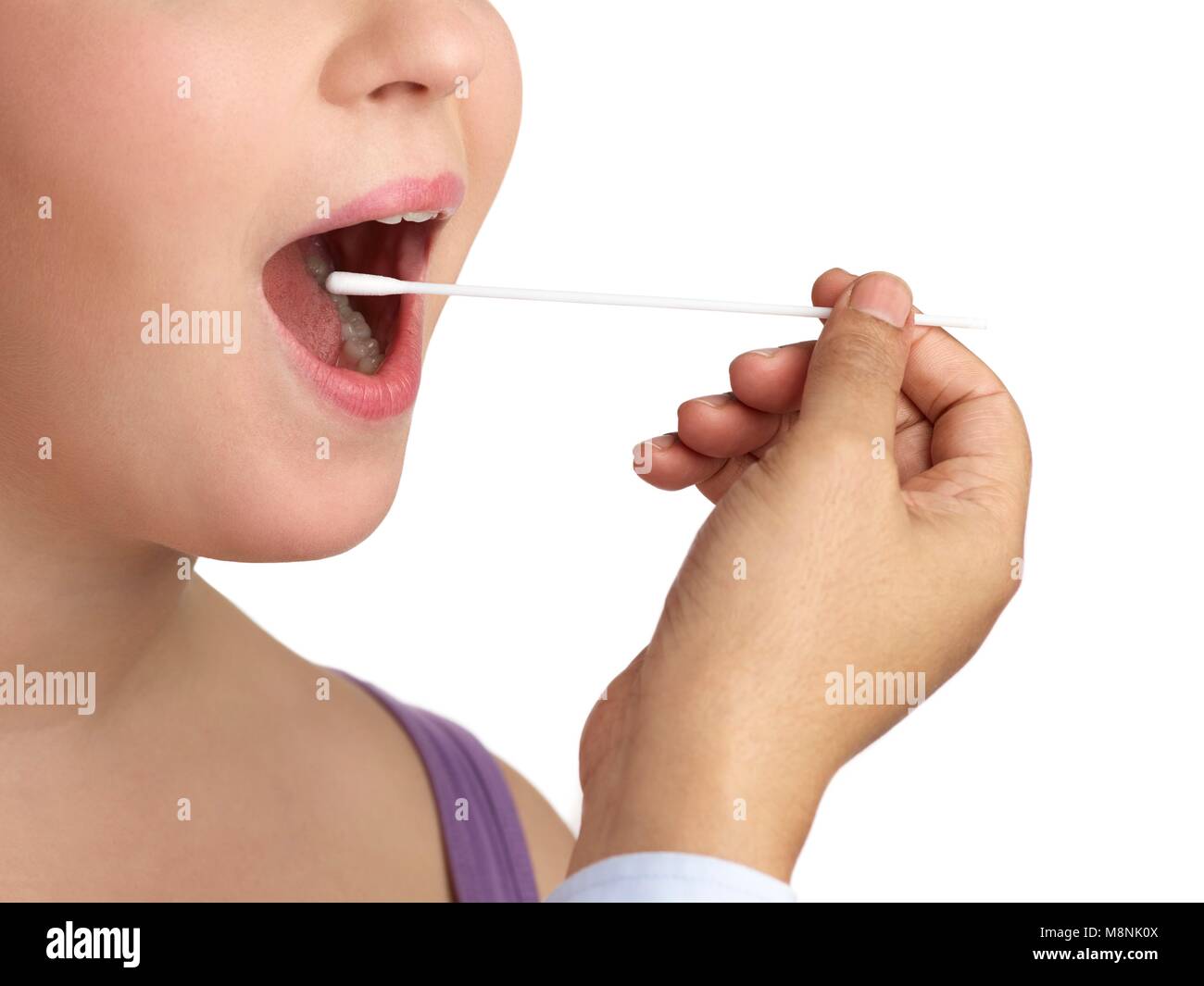 Doctor taking a swab from a woman's mouth. Stock Photo