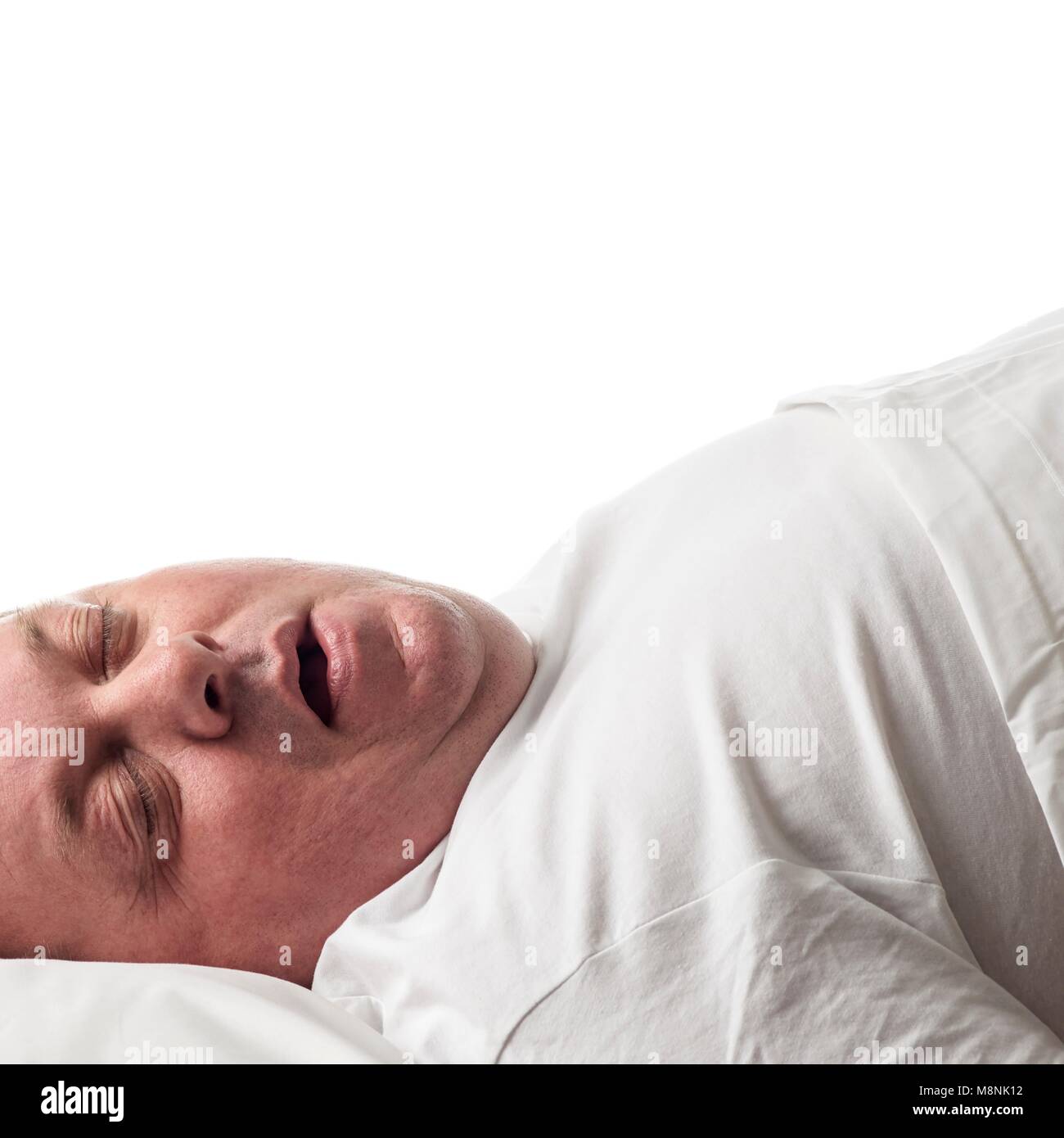 Overweight man lying down asleep. Stock Photo