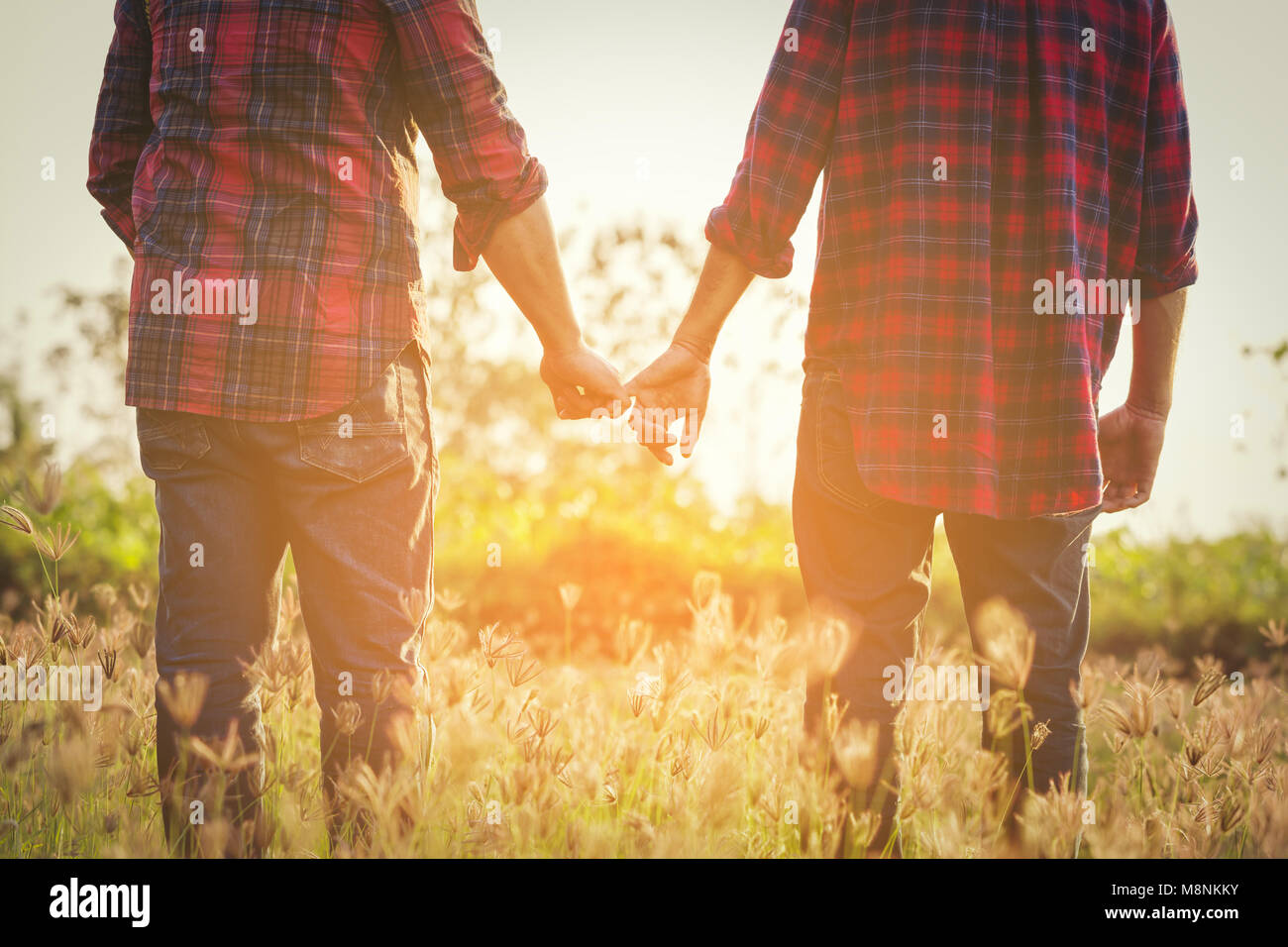 Young gay men holding hands hi-res stock photography and images - Alamy