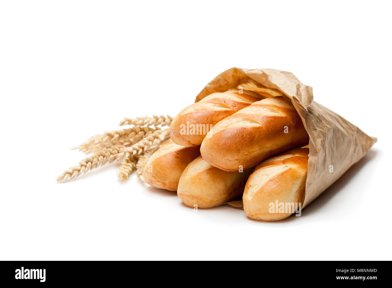 Mini  loaf bread in paper bag and wheat ears isolated on white background Stock Photo
