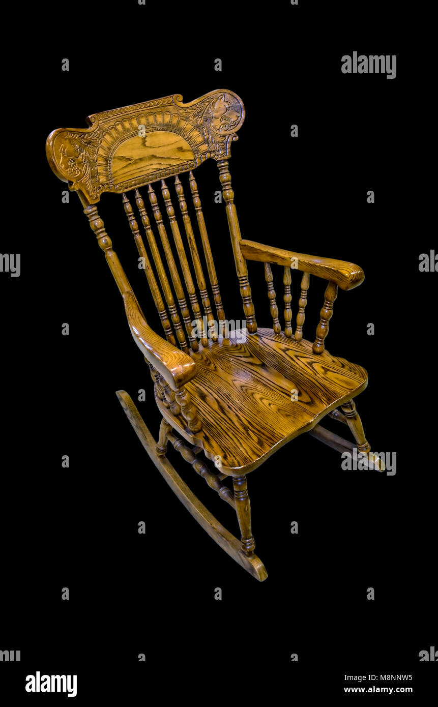 Wooden carved chair rocking brown on a black background, isolated Stock Photo