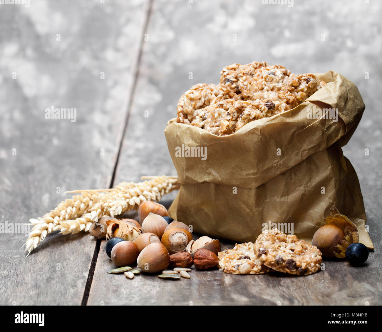 Healthy protein granola crackers with seeds and nuts in paper bag on