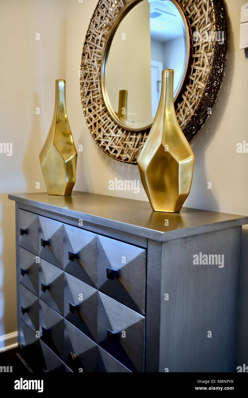 Modern dresser with gold accented furniture Stock Photo - Alamy