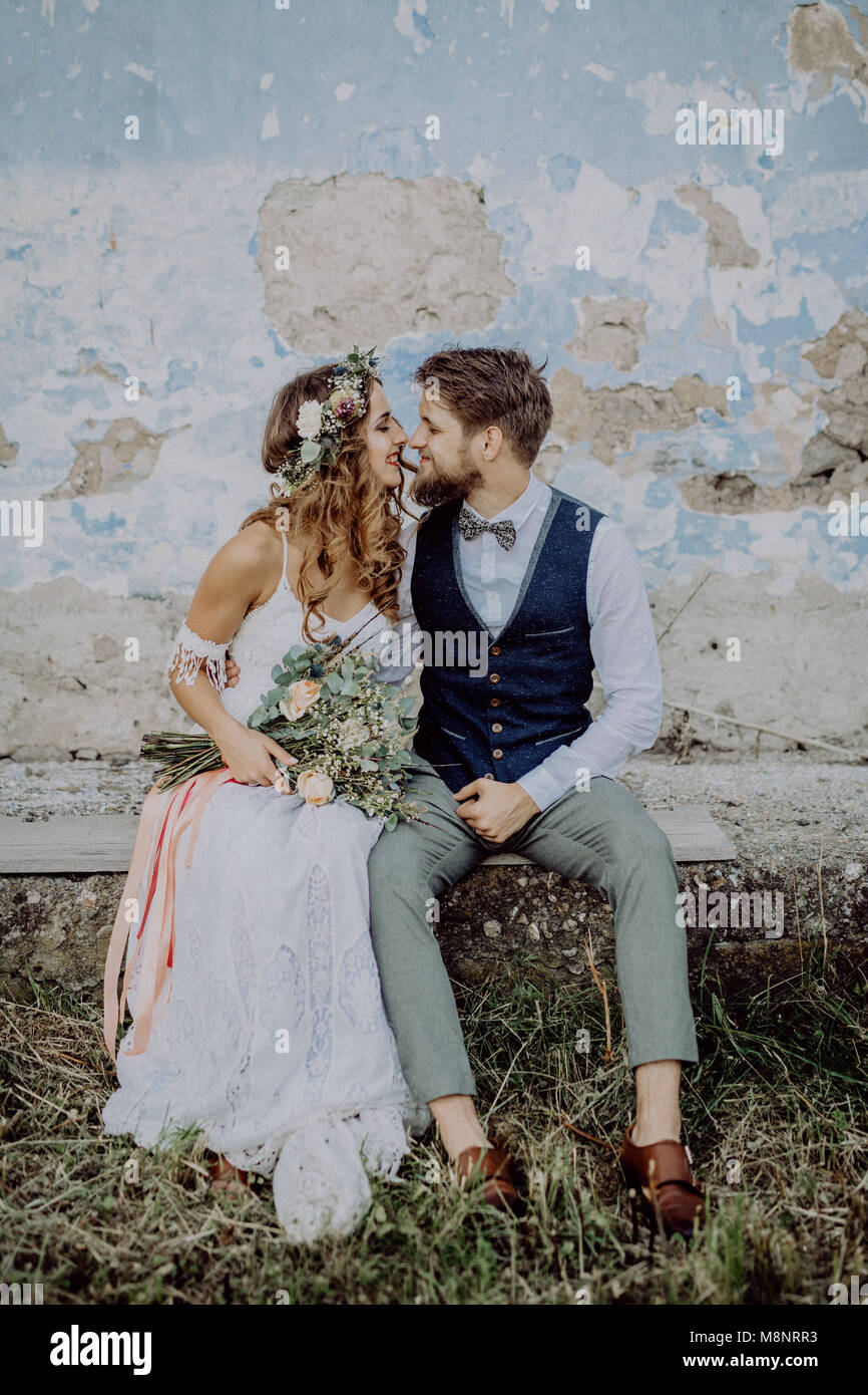 Beautiful bride and groom in front of old shabby house Stock Photo - Alamy