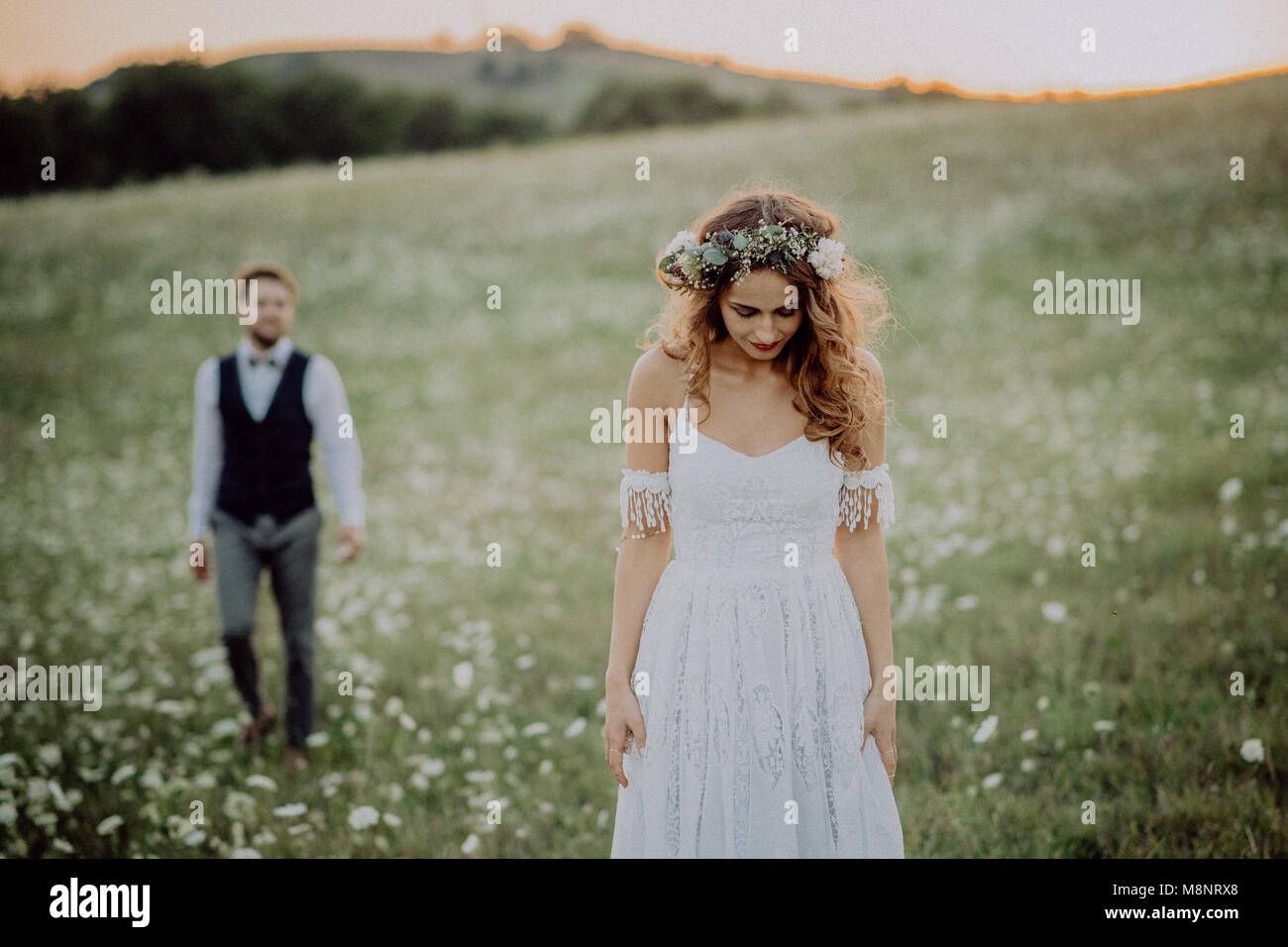 Beautiful bride and groom at sunset in green nature Stock Photo - Alamy