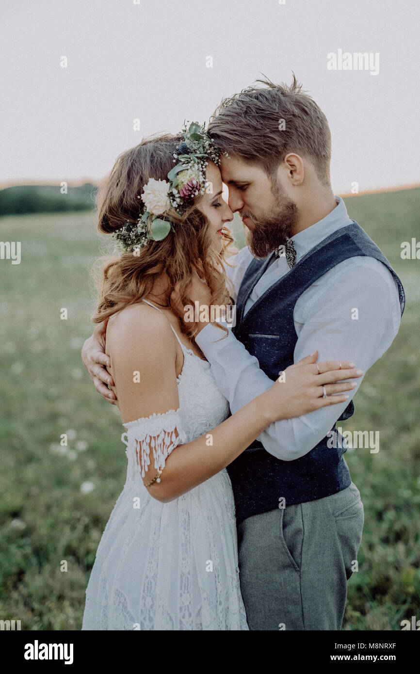 Beautiful bride and groom at sunset in green nature Stock Photo - Alamy