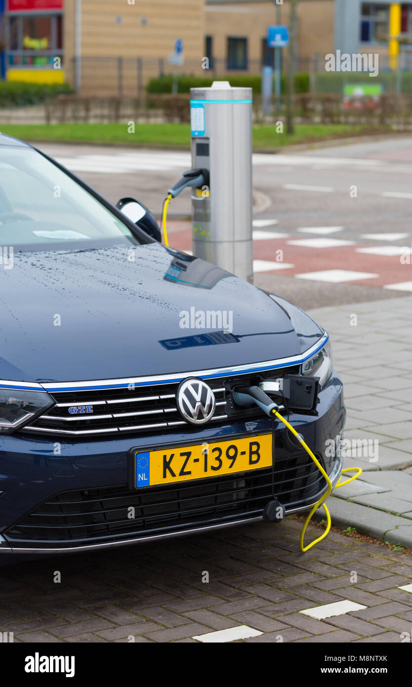 ROERMOND, NETHERLANDS - MARCH 19, 2017: Volkswagen Passat e-car being charged on the street Stock Photo
