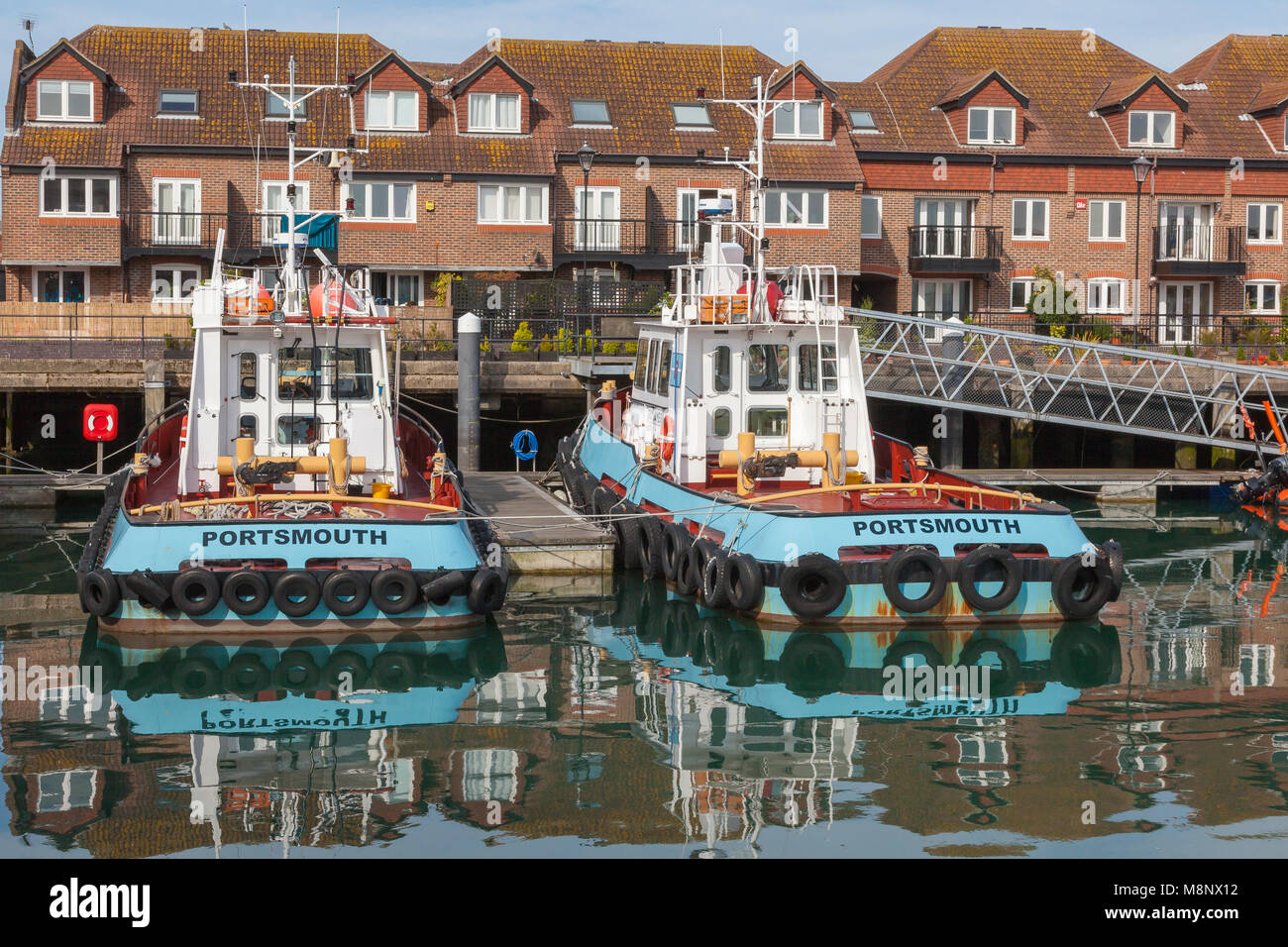 Views across the docks in Old Portsmouth, with fishing boats, yachts and tug boats moored, Portsmouth, Hampshire, UK Stock Photo