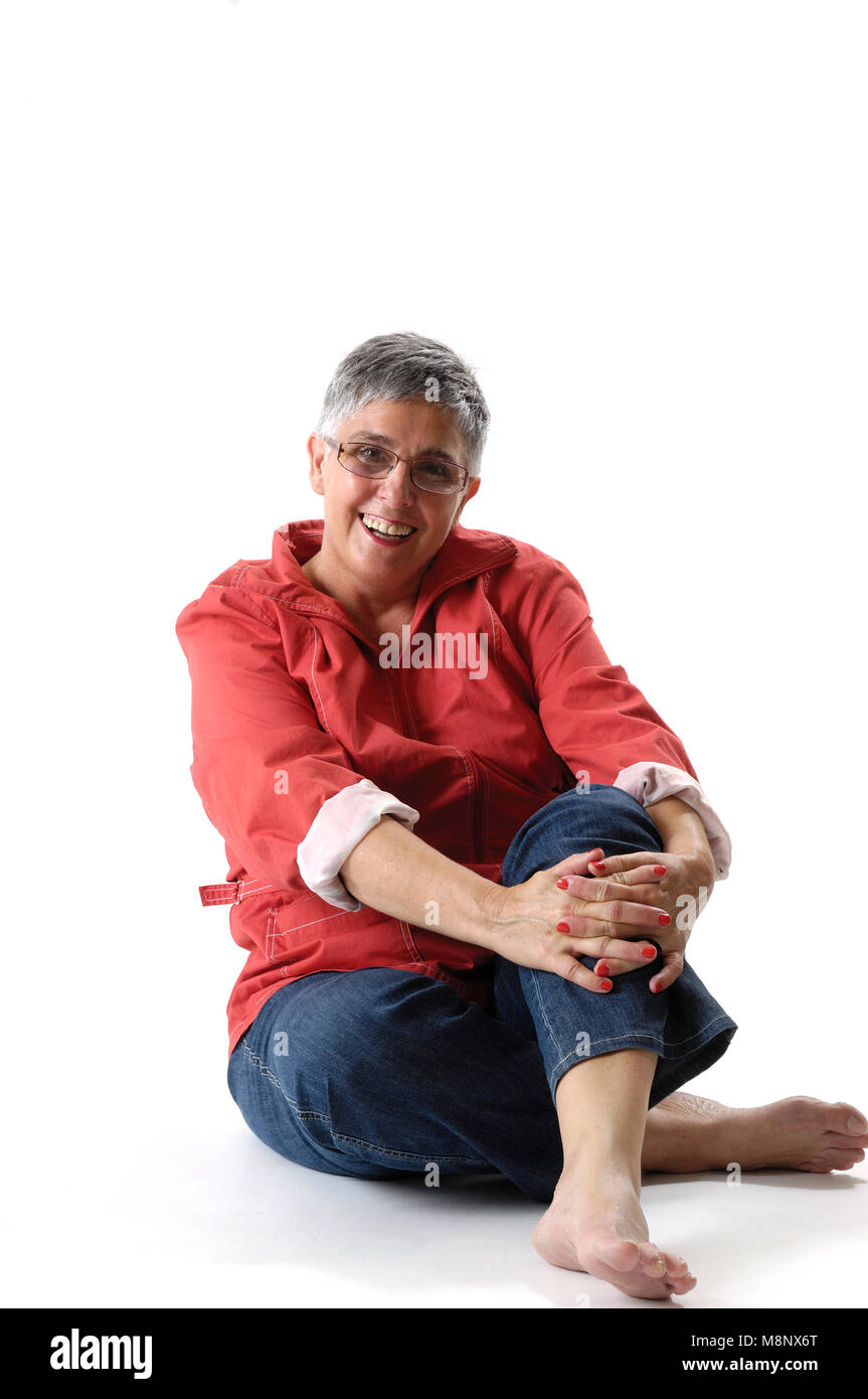 senior woman sitting on white background Stock Photo - Alamy