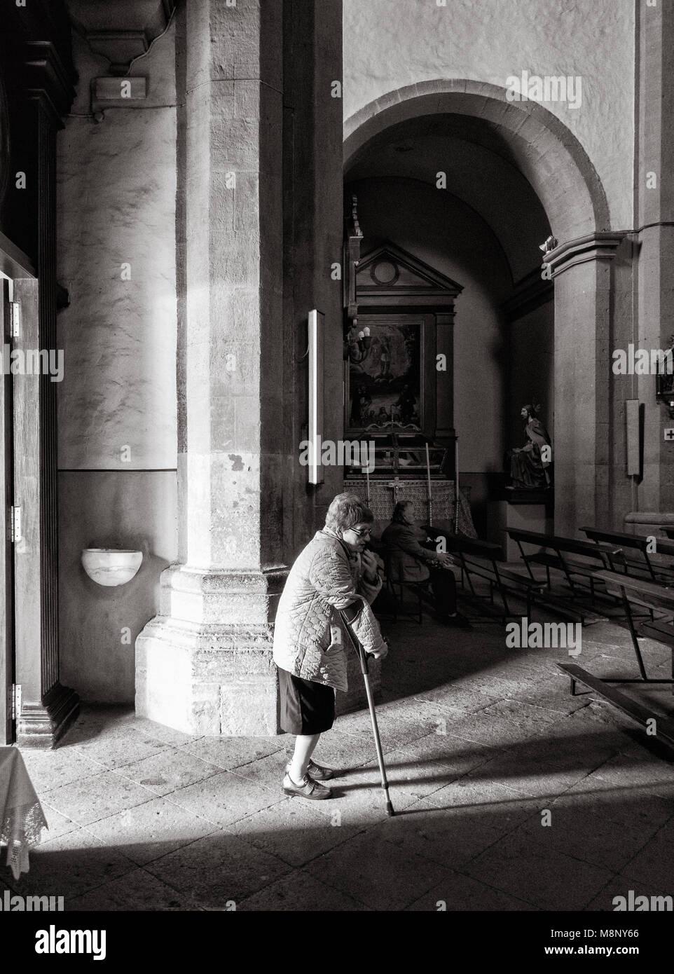 Elderly woman entering church in Spain Stock Photo