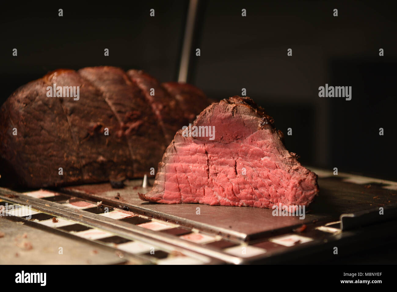 succulent food of pink tender roast beef and a whole joint of meat