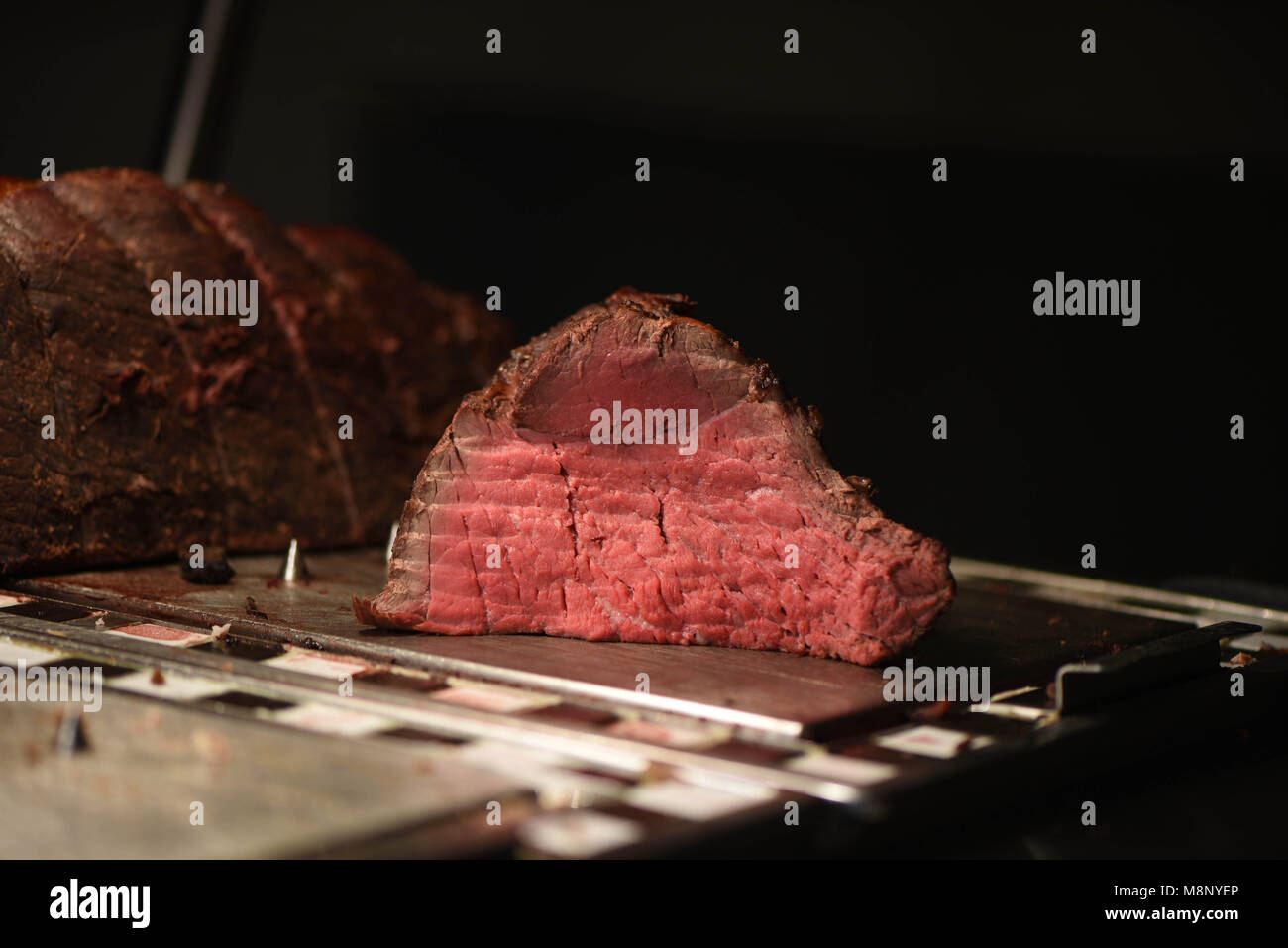 succulent food of pink tender roast beef and a whole joint of meat