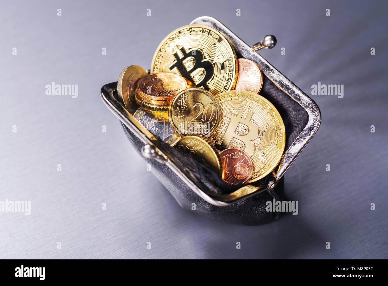 Wallet filled with two Bitcoin and many Euro coins | usage worldwide Stock Photo