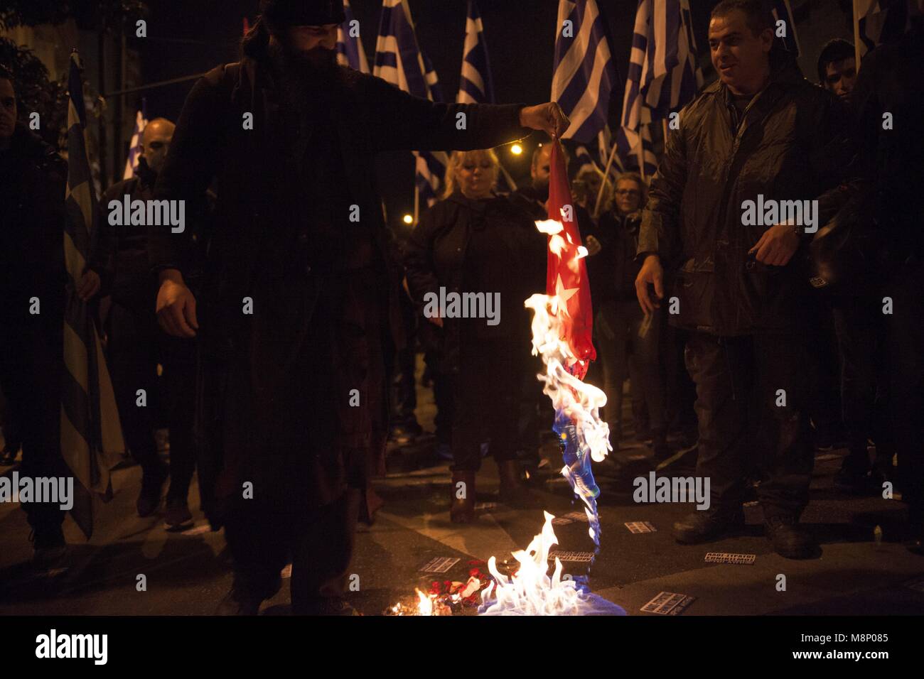 Members of Greek ultranationalist, far-right political party Chrysi Avgi (Golden Dawn) burn Turkish flag, during rally in Athens. 05.03.2018 | usage worldwide Stock Photo