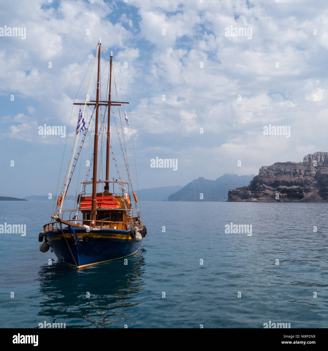 a small boat on the water in the caldera of santorini island, greece Stock Photo