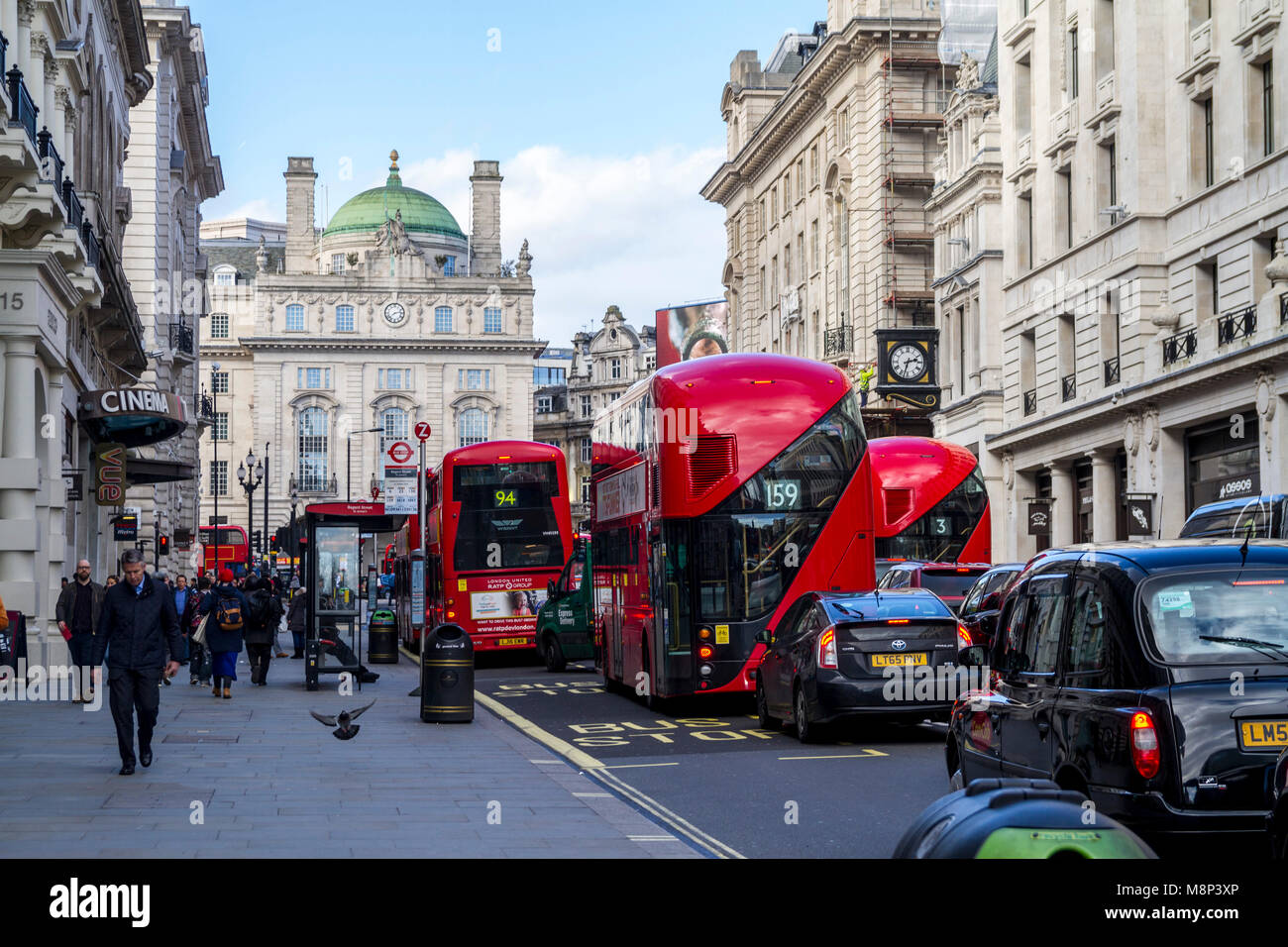 London traffic, red buses, black taxis, lower regent st, United kingdom london shoppers Stock Photo