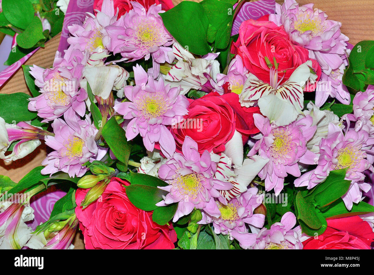 Beautiful colorful spring floral background - delicate bouquet of pink roses, chrysanthemums and white alstroemeria flowers Stock Photo