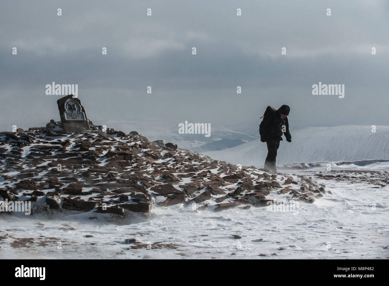A hiker battles against Arctic conditions on at the summit of Pen-y-fan in the Brecon Beacons National Park. Stock Photo