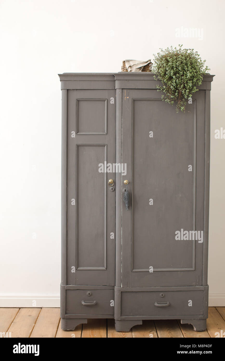Gray old vintage cupboard in white interior Stock Photo