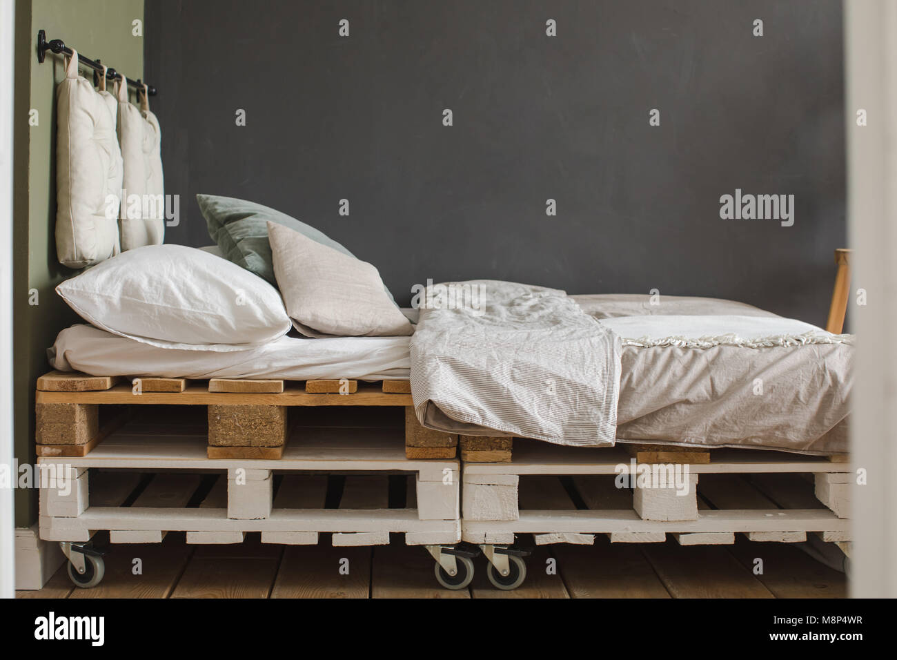 Industrial style bedroom recycled pallet bed frame Stock Photo