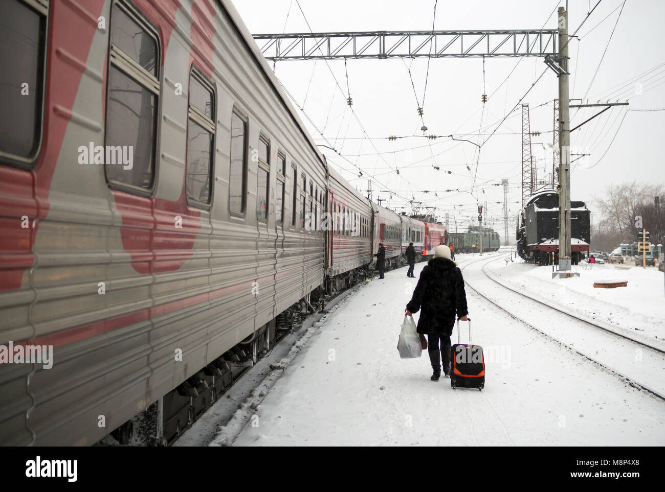 Petrozavodsk, Russia - January 15, 2016: The passenger is on the train station platform winter along the train Stock Photo