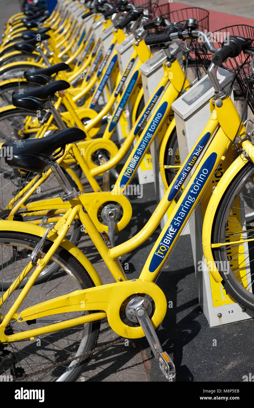 Yellow bicyles on a To Bike terminal in Turin or Torino, Italy Stock Photo