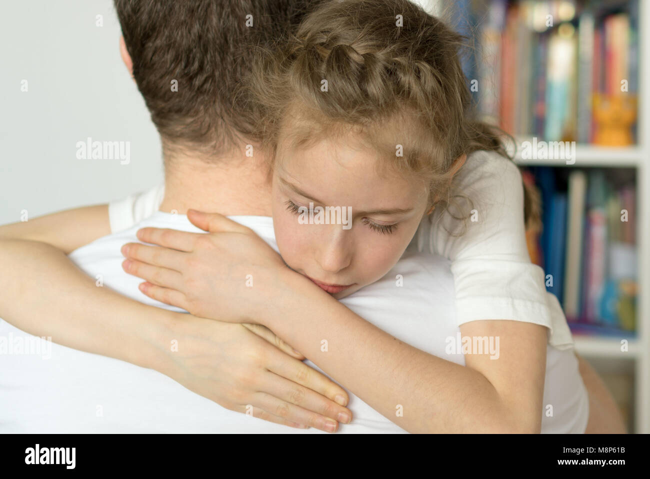 Sad little girl hugging her dad Stock Photo Alamy
