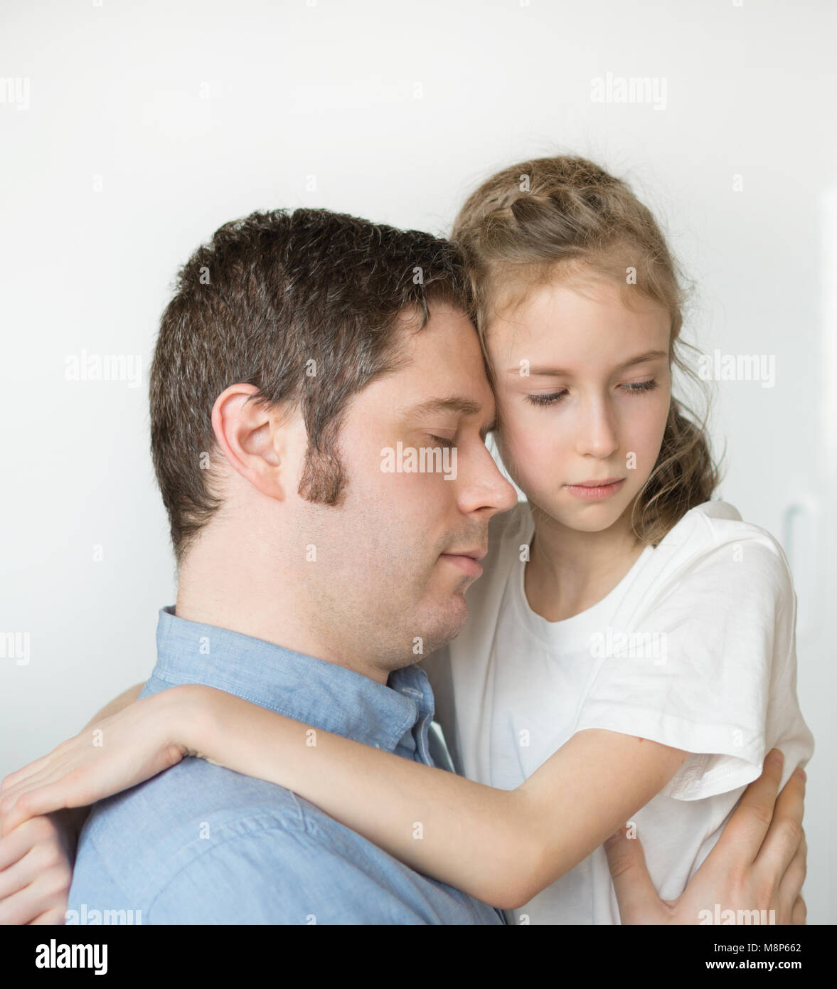 Sad little girl hugging her dad Stock Photo Alamy