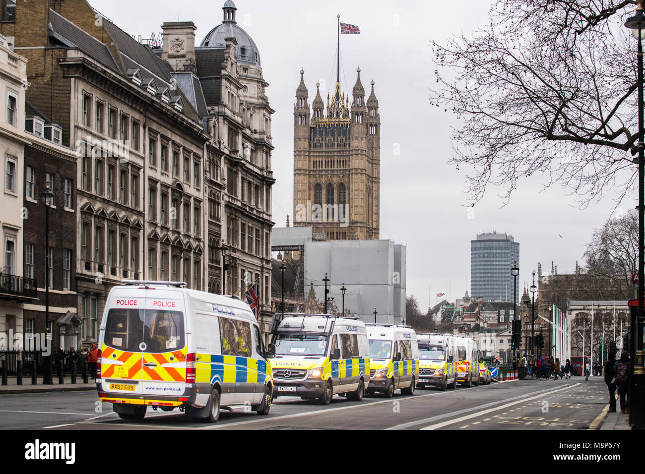 Police vehicles lined up on the central reservation of parliament street on a cold spring day at Westminster London, England. Stock Photo