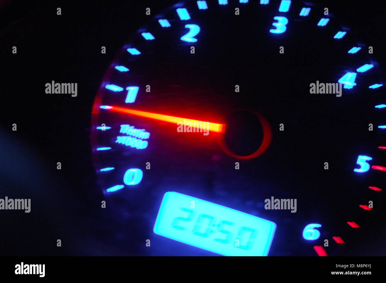 Close up image of rev counter in a van showing orange pointer numerals