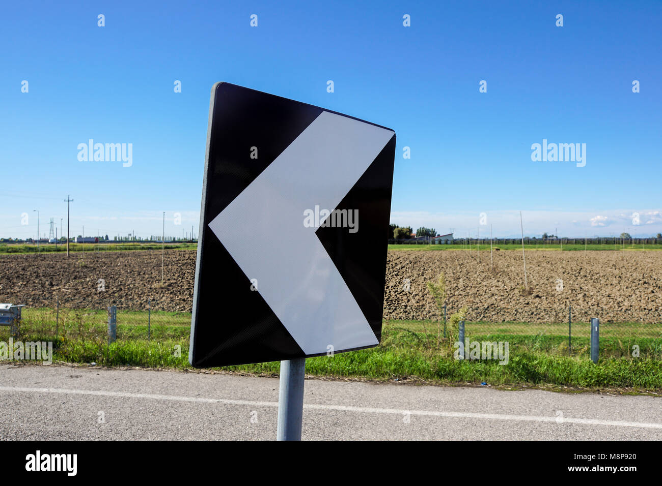 road signs indicating direction on curved road Stock Photo