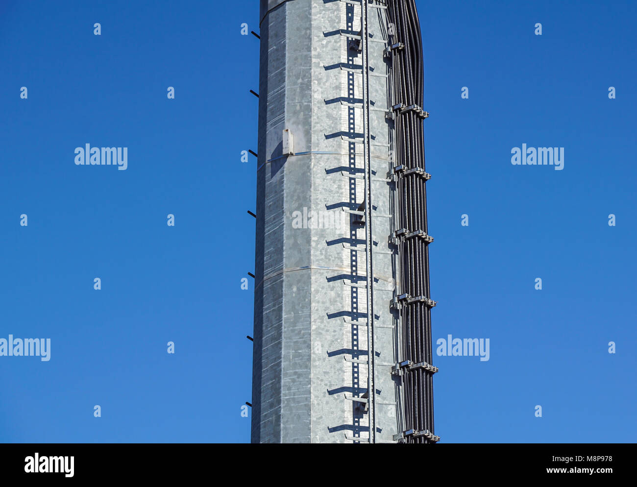 stairs to the comunications pole with wires and cable Stock Photo