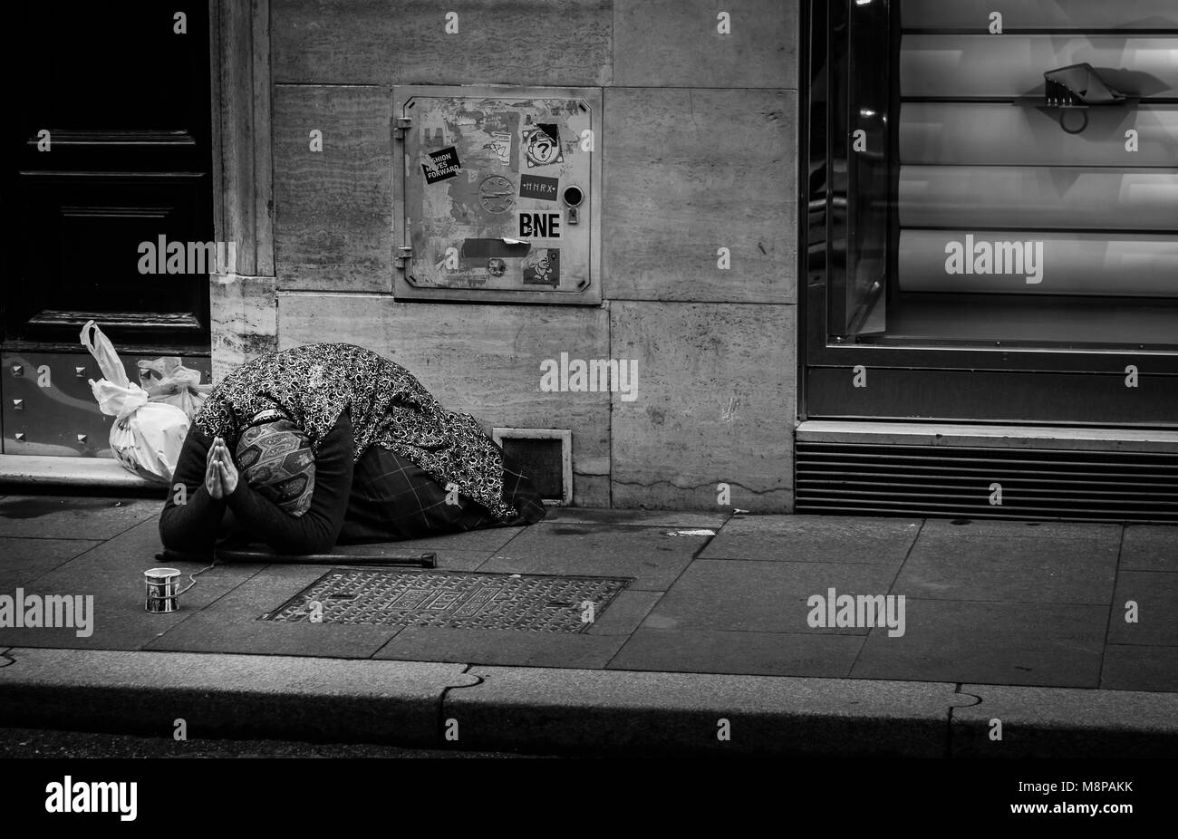 Old lady praying for money on the streets of Italy Stock Photo