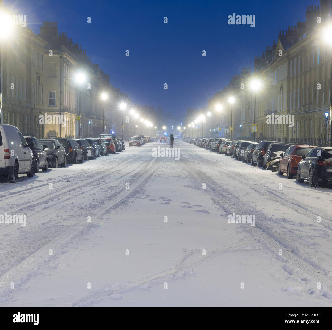 Great Pulteney Street at night in snow, with person walking in road. Majestic road in UNESCO World Heritage city after unusually heavy snowfall Stock Photo