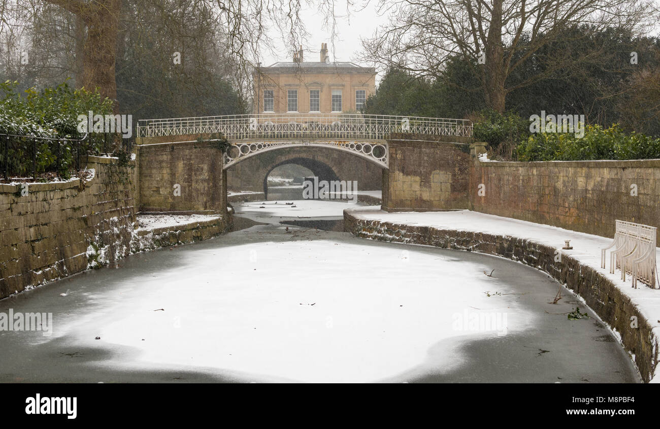 Kennet and Avon Canal frozen in Bath. Ice on surface of waterway by Sydney Gardens, running through centre of World Heritage City in Somerset, UK Stock Photo