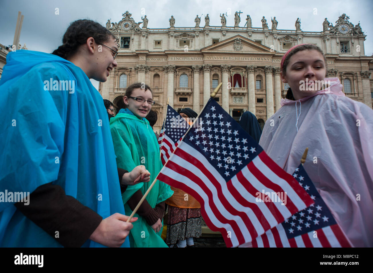 Vatican City. Faithfuls wave an American flag during the second day of the secret Conclave on March 13, 2013. Vatican. Stock Photo