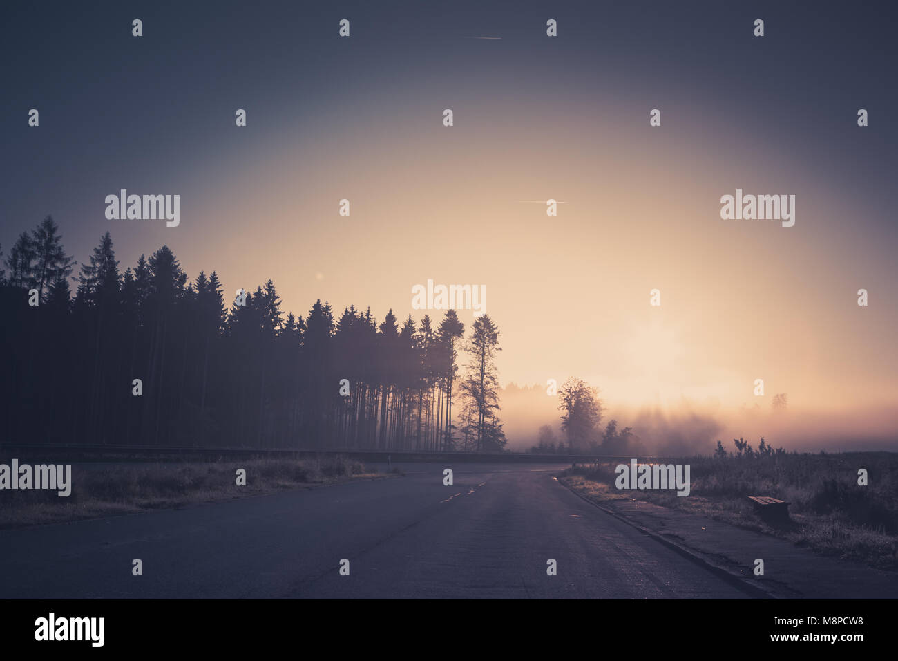 Surreal, romantic sunrise at the misty, foggy countryside. Stock Photo