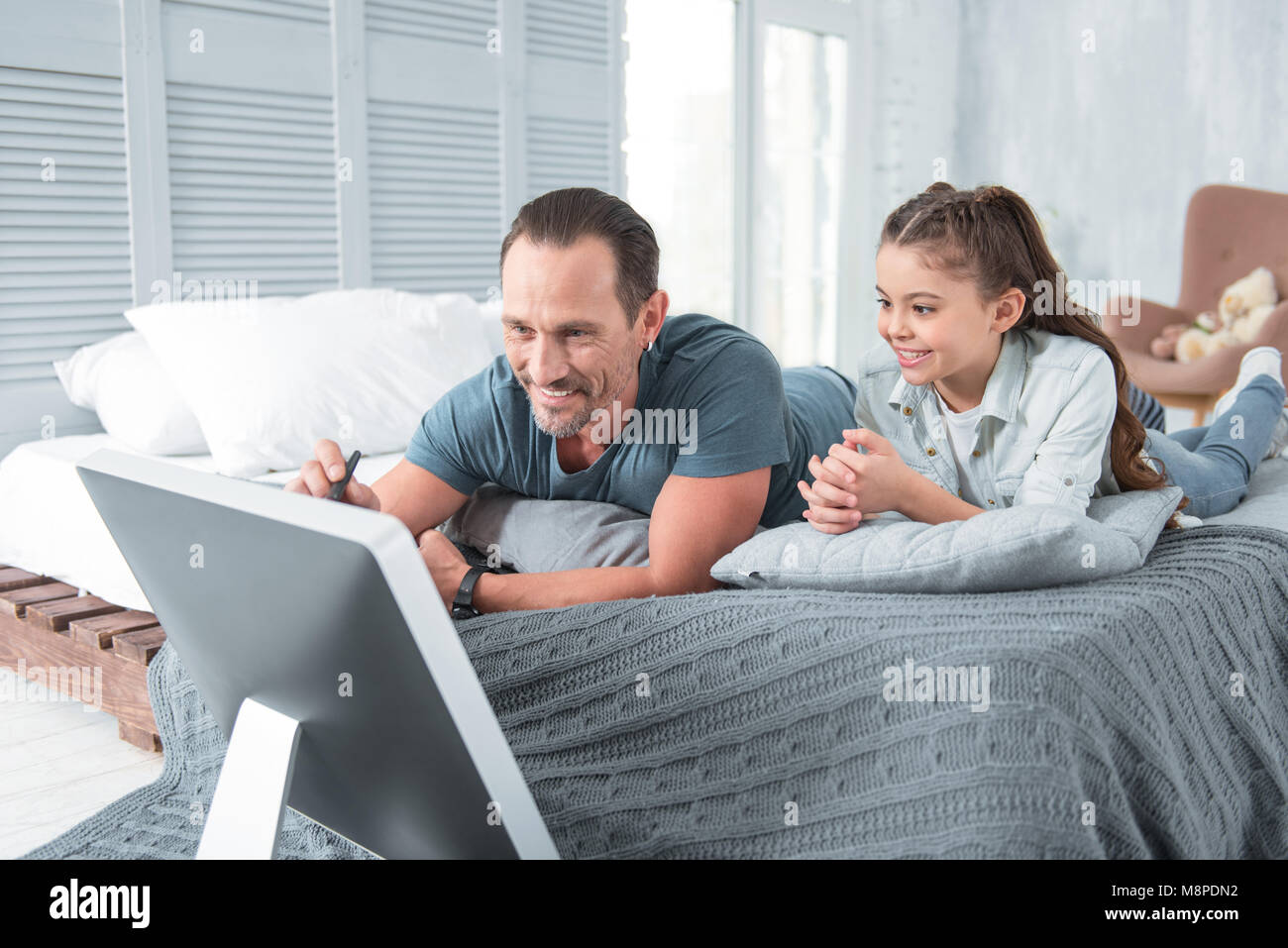 Nice delighted father teaching his daughter Stock Photo