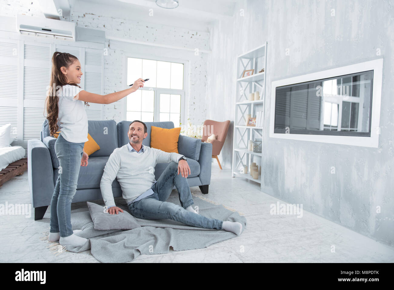 Positive happy girl standing in the living room Stock Photo - Alamy