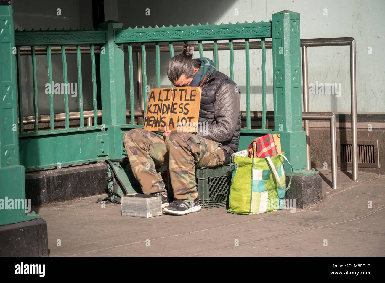 A homeless individual encamped outside a subway entrance in New York on Saturday, March 17, 2018. (© Richard B. Levine) Stock Photo